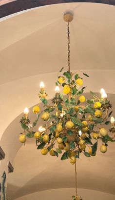 a chandelier with lemons hanging from it's sides in a church