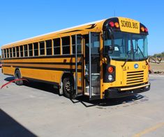 a yellow school bus parked in a parking lot