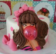 there is a cake with a woman blowing a bubble on it's face and holding a pink balloon in her mouth