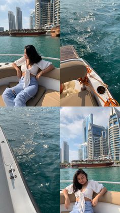 a woman sitting on the back of a boat in front of a cityscape