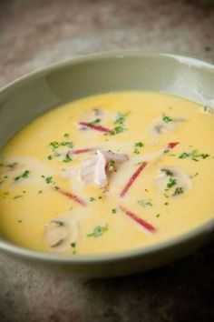 a green bowl filled with soup on top of a table