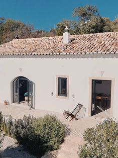 a white house with an open door and patio