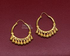 Amazing gold polished over pure 925 sterling silver amazing stylish antique design hoops earrings bali, fabulous hanging bells, awesome gifting tribal jewelry form Rajasthan india. Metal-925 Sterling silver. Type- stud earrings Stamp-925. Weight-12.040 grams length-4.4 centimeter with bells. Width-3.0 centimeter. Finish-Gold polished over 925 sterling silver bali. Makes excellent gifting and collectible pieces. Temple Jewelry Style Intricate Dangle Hoop Earrings, Intricate Dangle Hoop Earrings For Festivals, Festive Hoop Dangle Earrings With Latkans, Brass Temple Jewelry Hoop Earrings For Festivals, Traditional Dangle Hoop Earrings For Festivals, Traditional Hoop Jewelry For Festivals, Temple Hoop Earrings For Festivals, Temple Style Hoop Jewelry For Festivals, Festival Hoop Earrings With Latkans