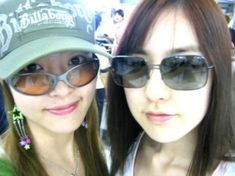 two young women wearing sunglasses and hats