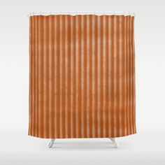 an orange shower curtain with vertical lines on the side and bottom, in front of a white background