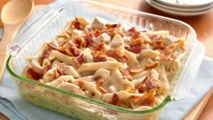 a casserole dish filled with pasta and bacon