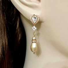 "One (1) pair of sparkly rose gold cz pearl drop bridal earrings made of clear cubic zirconia and unique champagne beige almond tone teardrop swarovski pearl dangles. Earrings are about 1 1/2\" (4cm) with sterling silver posts. View all rose gold jewelry at https://etsy.me/1mqy97w View all earrings at https://etsy.me/1f8VFT4" Gold Drop Chandelier Earrings For Anniversary, Gold Cubic Zirconia Bridal Earrings, Gold Dangle Crystal Earrings For Wedding, Gold Pear-shaped Bridal Earrings For Wedding, Gold Pear-shaped Cubic Zirconia Bridal Earrings, Gold Bridal Earrings With Elegant Design For Wedding, Elegant Gold Pear-shaped Bridal Earrings, Gold Dangle Pearl Earrings With Cubic Zirconia, Gold Teardrop Cubic Zirconia Earrings