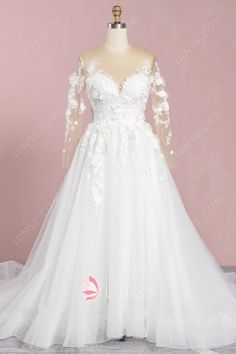 a white wedding dress with long sleeves and flowers on the bouncy skirt is displayed