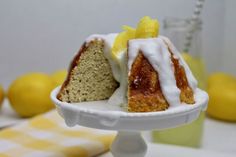 a piece of cake with white icing and lemons on top sitting on a plate