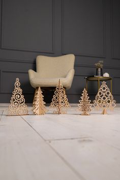 wooden christmas trees in front of a chair