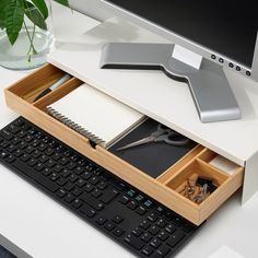 a computer desk with a keyboard, mouse and monitor on it's side shelf