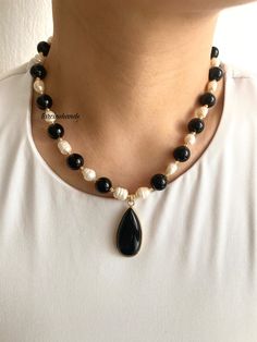 ✨Gold-Plated Black Agate and Freshwater Pearl Necklace | Black and White Elegant Necklace Enhance your jewelry collection with this stunning **Gold-Plated Necklace featuring the timeless contrast of **Black Agate** and **Freshwater Pearls**. This handcrafted necklace is a perfect accessory for both casual and formal occasions, adding a touch of elegance and sophistication to your style. ✨ **High-Quality Materials Made with durable gold-plated chains, this necklace combines the sleek look of **Black Agate** with the classic beauty of **Freshwater Pearls**. The gold plating ensures long-lasting shine and a luxurious appearance. 🖤 **Centerpiece The necklace is completed with a **Black Agate Pendant adding a bold and modern touch to the overall design. The agate's natural beauty complements t Elegant Black Beaded Necklaces With Stones, Black Necklaces With Round Natural Stones, Black Beaded Necklaces With Pearl Pendant, Black Beaded Necklace With Pearl Pendant, Elegant Onyx Crystal Necklaces With Natural Stones, Black Crystal Necklace With Natural Stones, Black Agate Beaded Necklace With Gemstones, Black Onyx Crystal Necklace With Natural Stones, Elegant Black Pendant Pearl Necklace