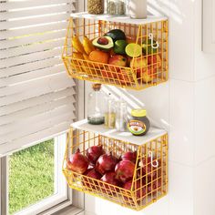 two yellow wire baskets filled with fruit on top of a white shelf next to a window