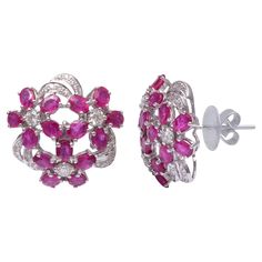 These earrings are made with Ruby gemstones and diamond. They are set in 18K gold. Shine all day long in this delicate pair of stud earrings. Perfect for gifting, they twinkle with timeless elegance. Easy to mix and match with other jewellery pieces. Specifications Dimensions: Length: 20 mm Width: 20 mm Gross Weight: 9.450 gms Gold Weight: 8.162 gms Gold Purity: 18K Yellow Gold Diamond Weight: 0.7 ct Ruby Weight: 5.71 ct SKU: SE-856C-18K Ruby Stud Earrings, Ruby Earrings Studs, Ruby Gemstone, Gold Stud, Gold Studs, Diamond Earrings Studs, Jewelry Earrings Studs, Jewelry Pieces, Gold Diamond