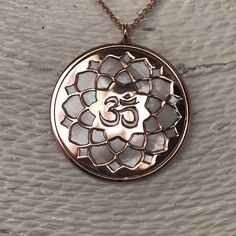 "Om in rose gold on 925 silver and white mother of pearl backdrop, spiritual yoga jewel, buddhist necklace. Om is one of the most important spiritual symbols, a sacred sound in Indian religions, found also in some chapters of the Veda. It has variously been associated with concepts of \"cosmic sound\" that celebrates the creative powers of the Universe. Its sound is made up of three syllabes (A-U-M): wakefulness / darkness / present, dream / unconscious / past, deep sleep / future truth. In the Spiritual Style Rose Gold Sterling Silver Necklace, Spiritual White Gold Necklace For Meditation, Spiritual Rose Gold Sterling Silver Necklace, Spiritual Rose Gold Sterling Silver Necklaces, Spiritual Gold Temple Necklace For Meditation, Engraved Rose Gold Spiritual Necklace, Spiritual Rose Gold Jewelry For Meditation, Spiritual Rose Gold Medallion Jewelry, Gold Spiritual Decorative Necklace