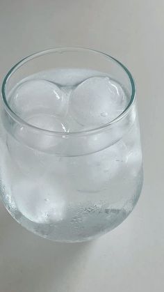 an empty glass filled with water and ice