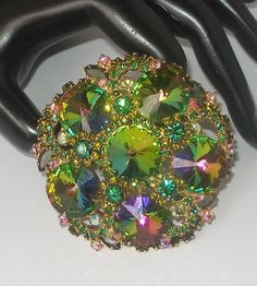 "Offering a Rare fabulous Juliana D & E Watermelon Rivoli Brooch.  This beautiful vintage brooch makes a statement and is a massive 3\".  There are six gorgeous Watermelon  Rivoli crystals accented with Olivine crystal florets, and clusters of round Emerald green and iridescent AB Crystals.  It is set in a gold metal and the craftsmanship is undeniably unmarked \"JULIANA\".   About Juliana D & E vintage jewelry:  The name \"Juliana\"is synonymous with jewelry made by DeLizza and Elster.  In the late 60s, Their magnificent designer jewelry pieces were originally marked only with paper hang tags.  This is one of those awesome pieces from their select group of savvy costume jewelry.  This is truly a collector's item and absolutely gorgeous!  The pictures don't really do it justice...It won't Juliana Jewelry Vintage, Juliana Jewelry, 1960s Dresses, 1960s Jewelry, Crystal Brooch, I Love Jewelry, Vintage Brooch, Vintage Costume Jewelry, Hang Tags