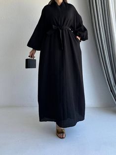 This black balloon sleeve dress is a chic and timeless piece, ideal for those who appreciate elegance and modern design. This dress features dramatic balloon sleeves, which add a touch of volume and sophistication to the overall silhouette.  Dress length: 55 in Sizes are standard. They are marked as 1 or 2. - Size 1 fits 36 EU (4 US), 38 EU (6 US), & 40 EU (8 US) - Size 2 fits 42 EU (10 US), 44 EU (12 US), & 46 EU (14 US) Wash & Care Instructions: - Dry clean only - Do not bleach - Iron with low Black Maxi Dress With Gathered Sleeves, Black Dress With Puff Blouson Sleeves, Chic Black Dresses With Blouson Sleeves, Chic Black Dress With Blouson Sleeves, Black Long Sleeve Dresses With Blouson Sleeves, Chic Long Sleeve Puff Sleeve Dress In Solid Color, Black Long-sleeve Dresses With Blouson Sleeves, Black Long Sleeve Dress With Blouson Sleeves, Chic Oversized Balloon Sleeve Dresses