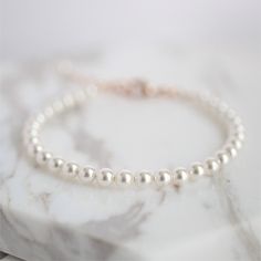 "* Flower Girl Swarovski Pearl Bracelet Perfect for the Flower Girls * * Beautiful Swarovski white pearl bracelet with a rose gold-filled 1/2\" extender chain. Shown with an optional rose gold-filled initial disc. * Other flower girl jewelry from J Jensen Weddings: * Swarovski White Pearl Flower Bracelet: https://www.etsy.com/listing/519679918/flower-girl-bracelet-brides-gift-flower * Swarovski Rose Gold Pearl Flower Girl Bracelet: https://www.etsy.com/listing/652741921/flower-girl-bracelet-rose Adjustable Pearl White Pearl Bracelet For Bridesmaids, Elegant White Bracelets, Classic Adjustable White Charm Bracelet, Classic White Adjustable Charm Bracelet, Adjustable Pearl Charm Bracelet For Wedding, Adjustable Pearl Bracelets For Bridesmaids, White Pearl Charm Bracelet For Wedding, White Pearl Beaded Bracelet For Bridesmaid Gift, White Pearl Drop Bracelet For Bridesmaids