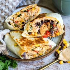 chicken burritos with black beans and corn on a plate