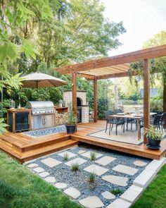 an outdoor kitchen and dining area with stone pavers flooring, wooden pergoline