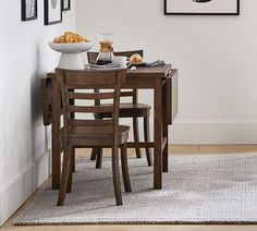 a dining room table and chairs with food on it