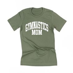 All Little Mama shirts are unisex sizing. They run slightly larger than typical women's shirts and slightly smaller than typical men's shirts. We recommend ordering your normal size for a regular fit.Please reference all size charts before purchasing.The default design color on this shirt is white, unless an option is given. Athleisure Cotton T-shirt With Team Name, Green Letter Print T-shirt For Gym, Basic Sports Tops With Screen Print, Basic Sports Top With Screen Print, Sporty Graphic Print Shirt For Gym, Cotton Gym Tops With Text Print, Sporty Gym Shirt With Letter Print, Sporty Green Shirt With Letter Print, Sporty Relaxed Fit Shirt For College