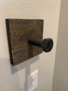 a wall mounted toilet paper dispenser on a white wall in a bathroom