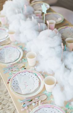 a table set up with clouds and plates