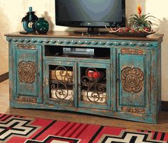 an ornately decorated entertainment center with a flat screen tv on it's stand