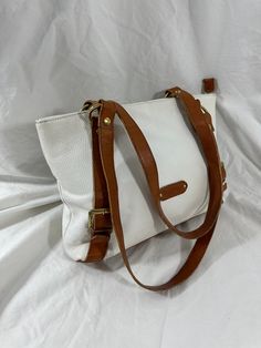 You are looking at a genuine vintage white shoulder bag by Valentina. Measurements are 14" top wide, 9"5 high, 3" deep with two 27" straps each and a 12" drop. On the interior there are two main compartments, back zipper pocket, mid zipper pocket, two small back pockets, lined in fabric and a top zipper closure. This Valentina tote is made of white/tan pebbled leather with gold tone hardware four bottom feet and exterior zipper pocket for easy to access items. Please note bag is not new and ther Vintage Double Handle Shoulder Bag For Errands, Elegant Large White Bag, Classic White Satchel With Large Capacity, Vintage White Top Handle Shoulder Bag, White Leather Top Handle Shoulder Bag, Vintage Double Handle Satchel For Errands, Classic White Large Capacity Satchel, Everyday Cream Shoulder Bag With Handle Drop, Vintage White Tote Shoulder Bag