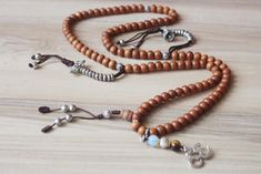 this is real sandall wood mala with fine quality beads 8mm mix with mala counter and om charms 108 beads 18inch long necklace Brown Wooden Beads Spiritual Mala, Spiritual Brown Wooden Beads Mala, Brown Wooden Beads Mala As Gift, Buddhist Mala, Om Charm, 108 Mala Beads, 108 Bead, Bubble Bag, Mala Beads