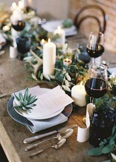 the table is set with place settings, candles and napkins for an elegant dinner