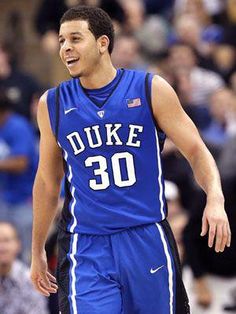 a male basketball player in a blue uniform is on the court and people are watching