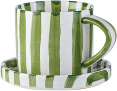 two green and white striped mugs sitting next to each other on top of each other