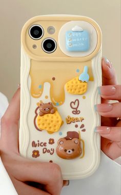 a person holding up a cell phone case with bear and giraffe stickers on it