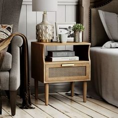 a living room scene with focus on the end table and chair next to the bed