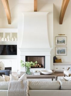 a living room filled with furniture and a fire place in the middle of a room