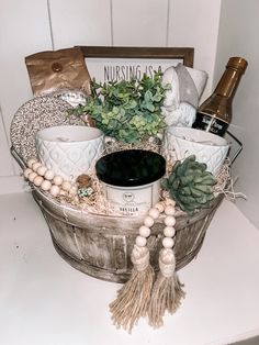 a basket filled with lots of different items on top of a white counter next to a bottle of wine