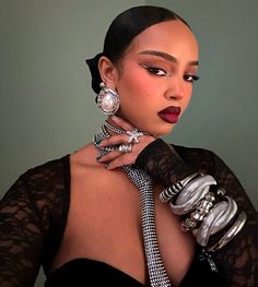 a woman in black dress with jewelry on her neck