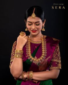 a woman in a purple and green sari with gold jewelry on her neck,