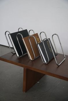 three pieces of luggage sitting on top of a wooden table