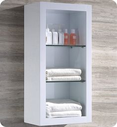 a white medicine cabinet with shelves and towels