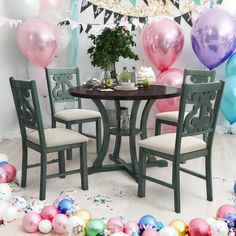 a table and chairs with balloons in the background