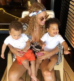 a woman and two children sitting on a boat