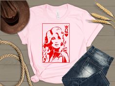 Dolly Parton Queen of Heart t-shirt. Sizes S-3X. Brands and color shades of the shirts vary.   Automatically comes on a pink crew neck. Please feel free to reach out for other styles, colors or sizes. Shirts are generally a cotton-feel polyester shirt which are used for sublimation printing. Pink Short Sleeve Shirt With Heart Graphic, Queen Of Heart, Pink Crew Neck, Heart T Shirt, Pink Crewneck, Pink T Shirt, Dolly Parton, Pink Tshirt, Queen Of Hearts