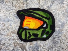 a close up of a patch on a stone surface with an image of a helmet