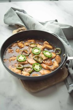 a skillet filled with chicken and jalapenos