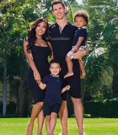 a family posing for a photo in the grass