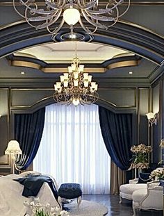 an elegant bedroom with chandelier and blue curtains